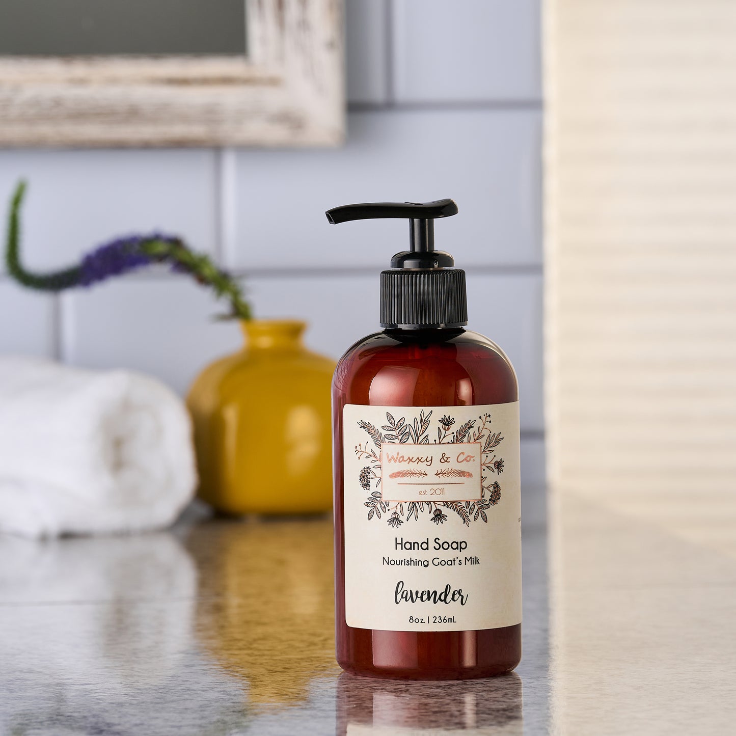 Hand soap bottle with a label on a bathroom counter